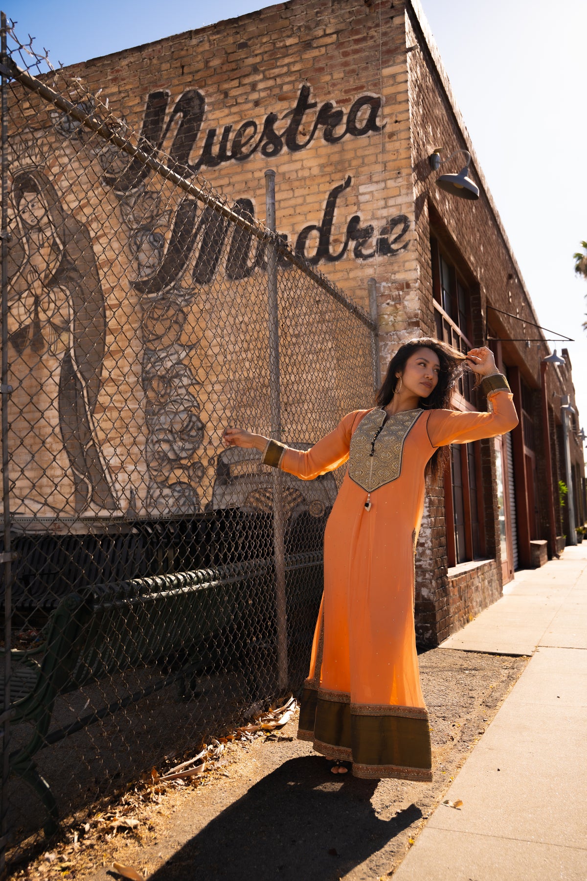 House of MEHDI campaign — orange dress at Questa Madre
