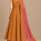 Amber Éclat back view with flared orange silhouette and pink scarf