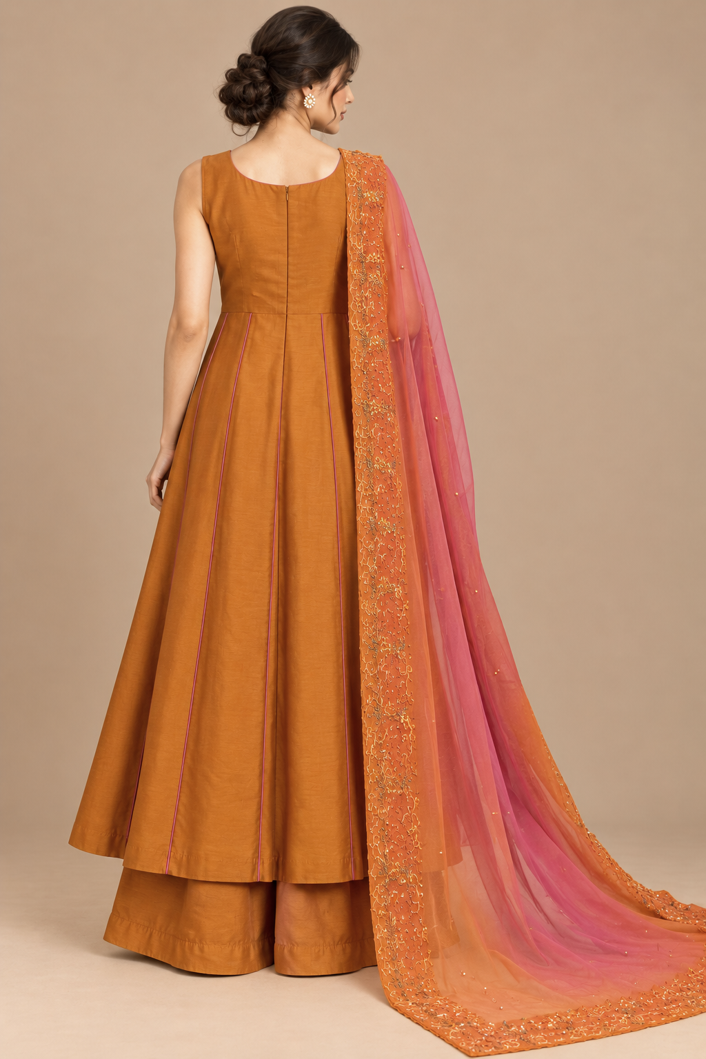 Amber Éclat back view with flared orange silhouette and pink scarf