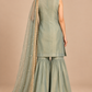 Elysia sage green outfit back view with flared trousers and embellished scarf